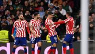 Atletico Madrid's defender Jose Gimenez (right) celebrates with teammates scoring his team's first goal during the Spanish League match between Real Madrid CF and Club Atletico de Madrid at the Santiago Bernabeu stadium in Madrid, on February 25, 2023. (Photo by OSCAR DEL POZO / AFP)