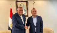 This handout picture released by the Egyptian Foreign Ministry shows Egypt's Foreign Minister Sameh Shoukri (left) meeting with his Turkish counterpart Mevlut Cavusoglu in Adana in central southern Turkiye on February 27, 2023. (Photo by Egyptian Foreign Ministry Spokesperson / AFP) 