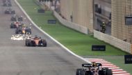 Red Bull Racing's Dutch driver Max Verstappen (right) leads the race ahead of Ferrari's Monegasque driver Charles Leclerc during the Bahrain Formula One Grand Prix at the Bahrain International Circuit in Sakhir on March 5, 2023. (Photo by Giuseppe CACACE / AFP)