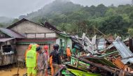 This handout photo taken and released on March 7, 2023 by the Natuna ministry of communication and information local office shows a rescue team inspecting damages and searching for victims following landslides in Natuna islands. (Photo by Handout / Natuna ministry of communication / AFP)