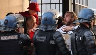 Police stand in front of fans prior to the UEFA Champions League final football match between Liverpool and Real Madrid at the Stade de France in Saint-Denis, north of Paris. File photo / AFP
