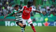 Sporting Lisbon's Portuguese forward Francisco Trincao (left) fights for the ball with Arsenal's English midfielder Bukayo Saka during the UEFA Europa League last 16 first leg football match between Sporting CP and Arsenal at Jose Alvalade stadium in Lisbon on March 9, 2023. (Photo by FILIPE AMORIM / AFP)