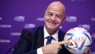 This file photo taken on March 31, 2022 shows FIFA president Gianni Infantino posing with Al Rihla, the official match ball before a press conference during the 72nd FIFA Congress in the Qatari capital Doha. (Photo by FRANCK FIFE / AFP)