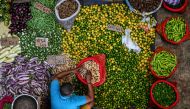 A vendor arranges vegetables as he waits for customers at a market in Colombo on March 21, 2023. - Sri Lanka must not allow entrenched corruption to undermine a bailout for its bankrupt economy, the IMF said on March 21, 2023 after signing off on a $3 billion loan for the crisis-hit nation. (Photo by ISHARA S. KODIKARA / AFP)