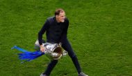 (FILES) In this file photo taken on May 29, 2021 Chelsea's German coach Thomas Tuchel celebrates with the trophy after winning the UEFA Champions League final football match at the Dragao stadium in Porto.