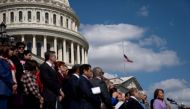 The US flag flies at half mast following the school shooting in Nashville, Tennessee, as House Democrats participate in a news conference on gun violence outside the US Capitol in Washington, DC, on March 29, 2023. (Photo by Stefani Reynolds / AFP)