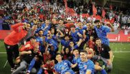 Al Duhail players and officials celebrate after winning the Ooredoo Cup final.