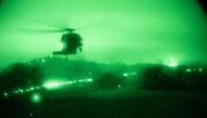 In this handout photo from the US Department of Defense, a Black Hawk helicopter with 2nd Combat Aviation Brigade supports 4-23 Infantry Regiment, 2nd Brigade, 2nd Infantry Division is seen through night vision on March 16, 2023, in the Republic of Korea during Exercise Warrior Shield.  (Photo by Handout / DoD / AFP)
