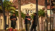 A secret service agent stands with security guards outside of the Mar-a-Lago Club, home of former US President Donald Trump, in Palm Beach, Florida, on April 1, 2023. - Trump is expected to surrender to the authorities in New York on April 4, 2023 to face charges over a hush-money payment to porn star Stormy Daniels. (Photo by Giorgio Viera / AFP)