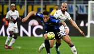 Inter Milan's Argentinian forward Lautaro Martinez (C) outruns Fiorentina's Moroccan midfielder Sofyan Amrabat (R) during the Italian Serie A football match between Inter and Fiorentina on April 1, 2023 at the Giuseppe-Meazza (San Siro) stadium in Milan. (Photo by GABRIEL BOUYS / AFP)