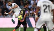 Real Madrid's French forward Karim Benzema (L) is challenged by Real Valladolid's Spanish midfielder Ramon Rodriguez 'Monchu' during the Spanish league football match between Real Madrid CF and Real Valladolid FC at the Santiago Bernabeu stadium in Madrid on April 2, 2023. Thomas COEX / AFP
