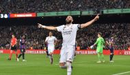 Real Madrid's French forward Karim Benzema celebrates after scoring his team's fourth goal during the Copa del Rey (King's Cup) semi-final second leg football match between FC Barcelona and Real Madrid CF at the Camp Nou stadium in Barcelona on April 5, 2023. Photo by Pau BARRENA / AFP