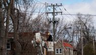 Hydro Quebec employees work on power lines on April 7, 2023, in Montreal, Canada after freezing rain hit parts of Quebec and Ontario on April 5. (Photo by ANDREJ IVANOV / AFP)