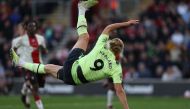 Manchester City's Norwegian striker Erling Haaland scores their third goal with this overhead kick during the English Premier League football match between Southampton and Manchester City at St Mary's Stadium in Southampton, southern England on April 8, 2023. (Photo by Adrian DENNIS / AFP)