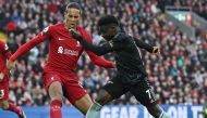 Liverpool's Dutch defender Virgil van Dijk (L) vies with Arsenal's English midfielder Bukayo Saka during the English Premier League football match between Liverpool and Arsenal at Anfield in Liverpool, north west England on April 9, 2023. (Photo by Paul ELLIS / AFP) 