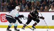 Nick Schmaltz #8 of the Arizona Coyotes skates the puck against Justin Schultz #4 of the Seattle Kraken during the second period at Mullett Arena on April 10, 2023 in Tempe, Arizona. Photo by Zac BonDurant / GETTY IMAGES NORTH AMERICA / Getty Images via AFP