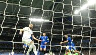 Real Madrid’s Karim Benzema (left) scores his team’s first goal against Chelsea yesterday. AFP