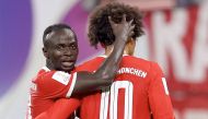 In this file photo taken on July 30, 2022 Bayern Munich's German midfielder Leroy Sane (right) celebrates scoring the 5-3 lead with Bayern Munich's Senegalese forward Sadio Mane during the German Supercup football match between RB Leipzig and FC Bayern Munich in Leipzig. (Photo by Ronny Hartmann / AFP)