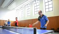 People play table tennis at the Ping Pong Parkinson initiative in Berlin on April 11, 2023, the World Parkinson's Day. Photo by Tobias SCHWARZ / AFP
