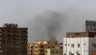 Smoke rises above buildings in Khartoum on April 15, 2023, amid reported clashes in the city. (Photo by AFP)