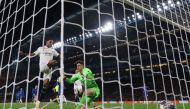 Real Madrid's Brazilian striker Rodrygo scores the team's second goal Chelsea's Spanish goalkeeper Kepa Arrizabalaga during the Champions League quarter-final second-leg football match between Chelsea and Real Madrid at Stamford Bridge in London on April 18, 2023. (Photo by Adrian DENNIS / AFP)