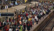 People crowd on platforms as they wait for their train at the Chhatrapati Shivaji Terminus (CST) railway station Mumbai on April 19, 2023. (Photo by Punit Paranjpe / AFP)