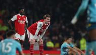 Arsenal's English defender Rob Holding (C) reacts on the pitch after the English Premier League football match between Arsenal and Southampton at the Emirates Stadium in London on April 21, 2023. - The game finished 3-3. (Photo by Adrian DENNIS / AFP) 