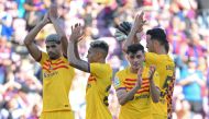 (From L) Barcelona's Uruguayan defender Ronald Araujo, Barcelona's Brazilian forward Raphinha, Barcelona's Spanish midfielder Pedri and Barcelona's Spanish midfielder Sergio Busquets applaud at the end of the Spanish league football match between FC Barcelona and Club Atletico de Madrid at the Camp Nou stadium in Barcelona on April 23, 2023. (Photo by LLUIS GENE / AFP)