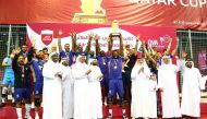 First Vice-President of the Qatar Olympic Committee Mohamed Yousef Al Mana and Qatar Volleyball Association President Ali Ghanem Al Kuwari applaud as Police players and officials celebrate with the trophy. 