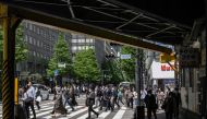 People cross a street in Yurakucho district of Tokyo on April 28, 2023. Photo by Yuichi YAMAZAKI / AFP