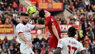 AC Milan's French forward Olivier Giroud (L) heads the ball during the Italian Serie A football match between AS Rome and AC Milan at the Olympic stadium in Rome on April 29, 2023. (Photo by Alberto PIZZOLI / AFP)
