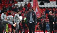 Liverpool's German manager Jurgen Klopp (C) watches his players warm up ahead of the English Premier League football match between Liverpool and Tottenham Hotspur at Anfield in Liverpool, north west England on April 30, 2023. (Photo by Paul Ellis / AFP)