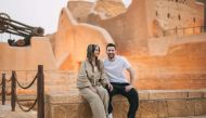 This handout picture provided by the Saudi Tourism Authority on May 1, 2023, shows Argentina's forward Lionel Messi and his wife Antonela Roccuzzo visiting Diriyah near Riyadh. (Photo by Saudi Tourism Authority / AFP)