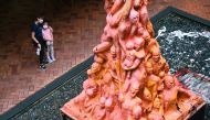 In this file photo taken on October 10, 2021, a woman and child look at the 'Pillar of Shame', a statue that commemorates the victims of the 1989 Tiananmen Square crackdown in Beijing, at the University of Hong Kong (HKU) in Hong Kong. (Photo by Peter Parks / AFP)