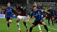 (FILES) In this file photo taken on February 05, 2023 Inter Milan's Argentinian forward Lautaro Martinez (R) and AC Milan's French defender Pierre Kalulu (L) Photo by MIGUEL MEDINA / AFP