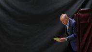 Turkish President Tayyip Erdogan walks out of a voting booth at a polling station to vote in the presidential and parliamentary elections, in Istanbul, on May 14, 2023. (Photo by UMIT BEKTAS / POOL / AFP)