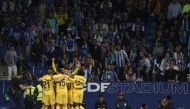 Barcelona's players celebrate their opening goal scored by Polish forward Robert Lewandowski celebrates scoring the opening goal during the Spanish league football match between RCD Espanyol and FC Barcelona at the RCDE Stadium in Cornella de Llobregat on May 14, 2023. (Photo by Josep LAGO / AFP)
