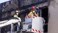 Firefighters inspect the Loafers Lodge hostel where a fire broke out a day earlier in the suburb of Newtown in Wellington on May 17, 2023. Photo by Marty MELVILLE / AFP
