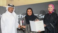 Moza Khalid Al Muhannadi - Director CSR, Sponsorship and Media at Ooredoo (centre) receiving the award.