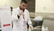 A QRCS doctor providing treatment in Gaza.