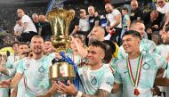 Inter Milan's Argentinian forward Lautaro Martinez (C) celebrates with the trophy after winning the Italian Cup (Coppa Italia) final football match between Fiorentina and Inter Milan at the Stadio Olimpico in Rome, on May 24, 2023. (Photo by Alberto PIZZOLI / AFP)
