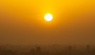 (Files) Tokyo's skyline is seen through the dusty air from the I-link Town observatory during the evening hour in Ichikawa city, Chiba prefecture, east of Tokyo on April 13, 2023. (Photo by Philip Fong / AFP)
 