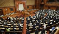 Members of the chamber vote to pass the revised Immigration Control and Refugee Recognition Act, which reviews the detention and deportation rules of foreigners, during a plenary session of the House of Councillors at the parliament building in Tokyo on June 9, 2023. (Photo by JIJI Press / AFP) 