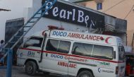 An ambulance enters the site of an attack at the Palm Beach Hotel in Mogadishu on June 10, 2023. (Photo by Hassan Ali Elmi / AFP)