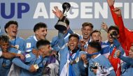 Uruguay's midfielder Fabricio Diaz (C) holds the trophy along with his teammates after defeating Italy and winning the Argentina 2023 U-20 World Cup at the Estadio Unico Diego Armando Maradona stadium in La Plata, Argentina, on June 11, 2023. (Photo by Luis ROBAYO / AFP)
