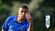 France's forward Kylian Mbappe throws a bottle during a training session ahead of the upcoming UEFA Euro 2024 football tournament qualifying matches in Clairefontaine-en-Yvelines, on June 12, 2023.  Photo by FRANCK FIFE / AFP