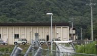 Vehicles and members of Japan's Ground Self-Defense Force (SDF) are pictured outside a building at the Hino basic firing range in the city of Gifu, Gifu prefecture, on June 14, 2023. (Photo by JIJI Press / AFP) 
