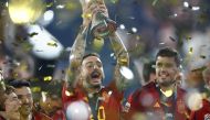 Spain's forward Joselu (C) holds the UEFA Nations League Cup  (Photo by KENZO TRIBOUILLARD / AFP)