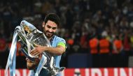 (FILES) Manchester City's German midfielder #8 Ilkay Gundogan poses with the European Cup trophy as they celebrate winning the UEFA Champions League final football match between Inter Milan and Manchester City at the Ataturk Olympic Stadium in Istanbul, on June 10, 2023. (Photo by Paul ELLIS / AFP)
