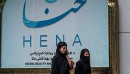 Women walk past a beauty salon at the Shahr-e Naw area in Kabul on July 4, 2023. (Photo by Wakil Kohsar / AFP)

